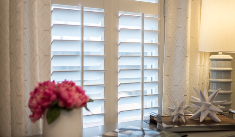 Plantation shutters by flowers in Dallas